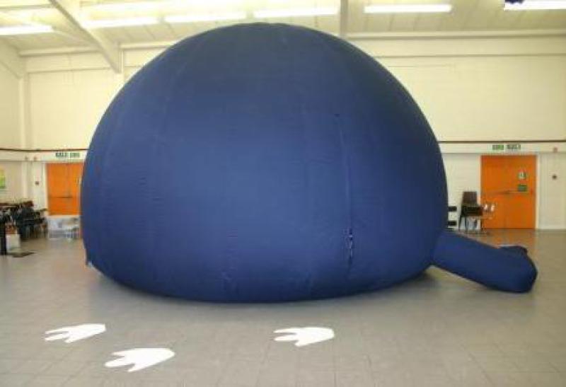 An indoor planetarium for children with dinosaurs footprints marked on the venue floor