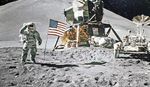 An image of the moon landing with Neil Armstrong and an American flag