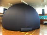 An indoor dome for planetarium shows inside a school room